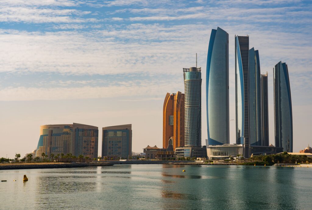 Panoramic view of modern skyscrapers and towers across the water, illustrating the operational area for heavy item movers Abu Dhabi.