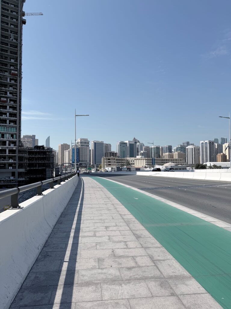 Modern residential towers and high-rise apartments along an Abu Dhabi highway, representing targeted service areas for studio movers Abu Dhabi.