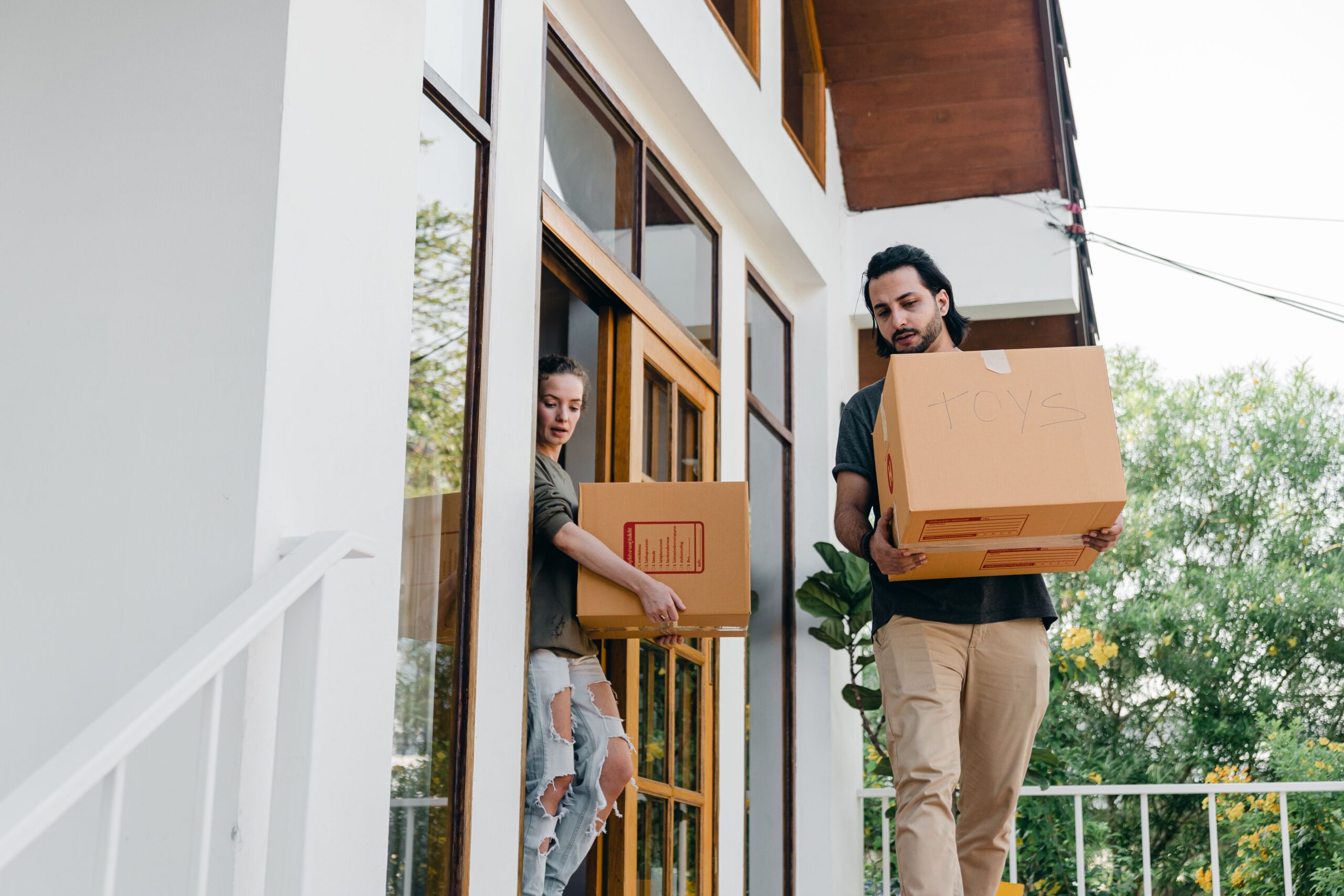 Reliable house movers Abu Dhabi shifting boxed belongings out of a townhouse property.